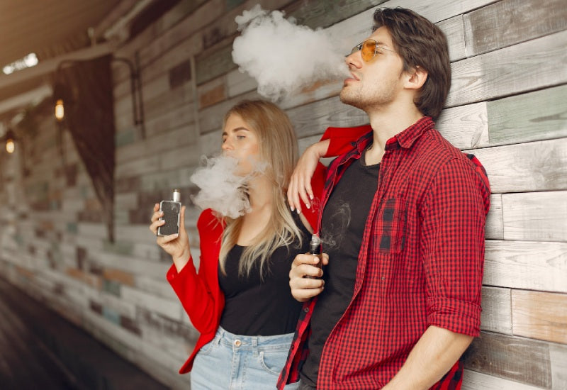 A man and woman smoking hookah